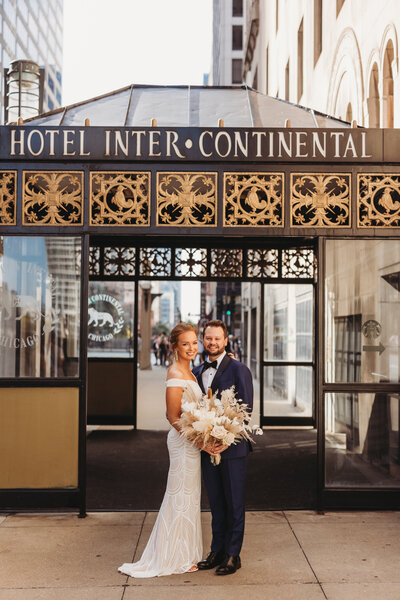 Wedding session of couple standing in front of hotel venue