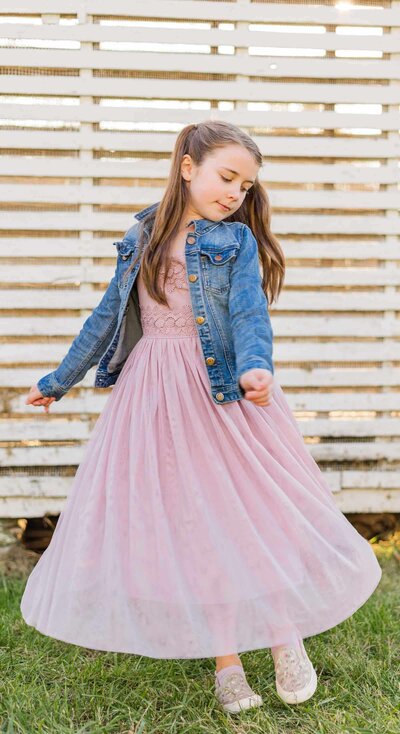 Young girl twirls in front of Valley Forge Park during photo session