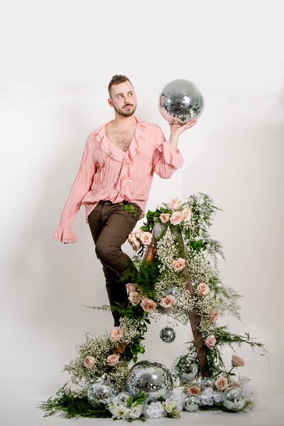 Sean holds a disco ball