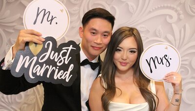 couple using props at their wedding reception