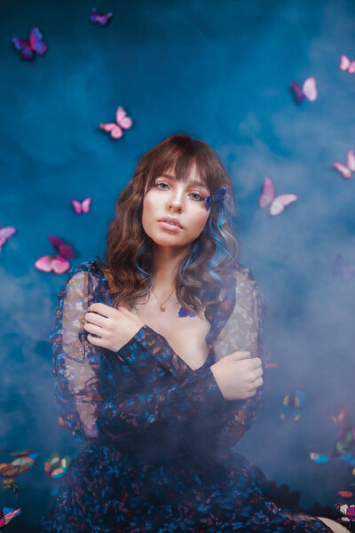 woman in blue and pink butterfly dress