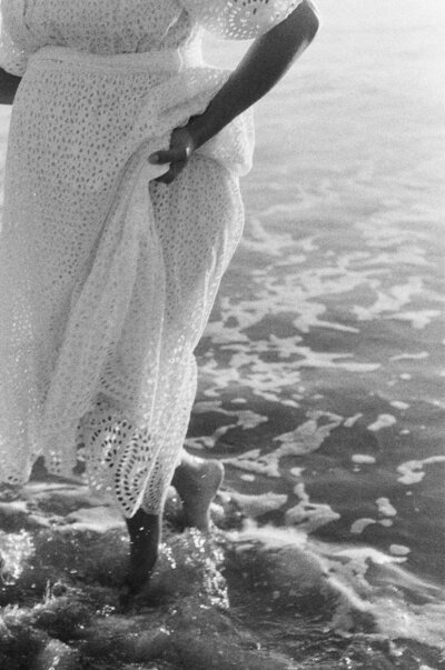 woman with long dress in foamy water 