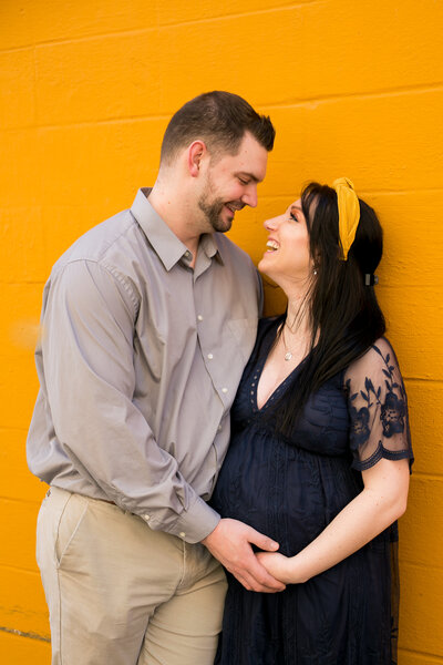 Photo of Expecting Parents holding belly | Maternity Session