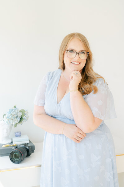Brittany smiling in a blue dress