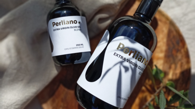 A premium olive oil bottle featuring custom die-cut labels and elegant gold foil accents, designed to exude sophistication and highlight the product's artisanal quality.