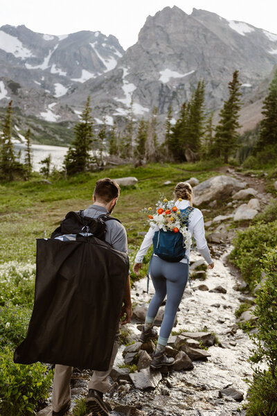 groom and bride kissing and showing off their wedding rings to their colorado elopement photographer