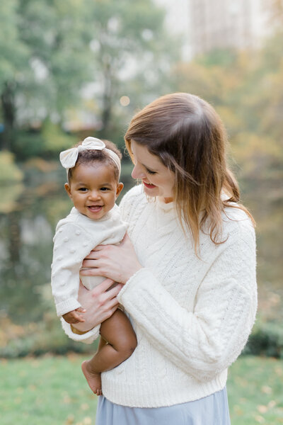 Mom holding daughter by Brooklyn family photographer