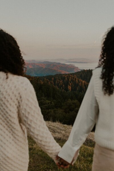 Couple holding hands with a view of the mountains