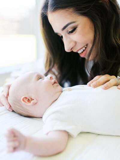 new mom with her baby during in-home photo session