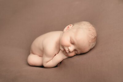 baby girl in heart shaped wood bowl in newborn photography in portland
