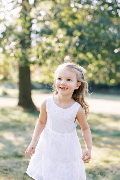 Little girl runs in outdoor field in Mechanicsburg