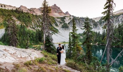 a couple standing in the mountains during their sunset Washington Elopement at Mount Rainier National Park