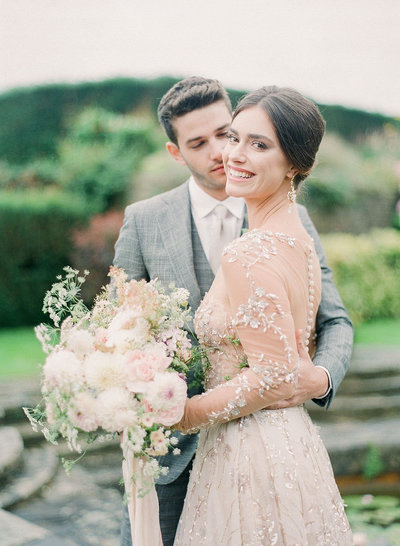 Bespoke gray groom suit and couture beaded bridal gown for a multi-day destination wedding