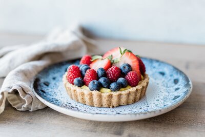 Gluten-free berry tart topped with strawberries and blueberries, made fresh at Grain Artisan Bakery in Snohomish.