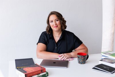 Life transitions therapist, Kathryn Konicek, sitting at her desk in Canon City