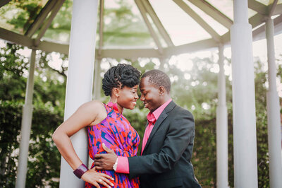Engagement photography session of a couple embracing under a gazebo in Orlando, Florida.