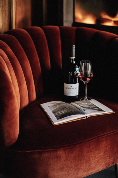 ammithre_dark_burgundy_velvet_chair_with_a_dark_wine_bottle_and_f31e06d2-0d40-4443-a040-86ca19ae664d