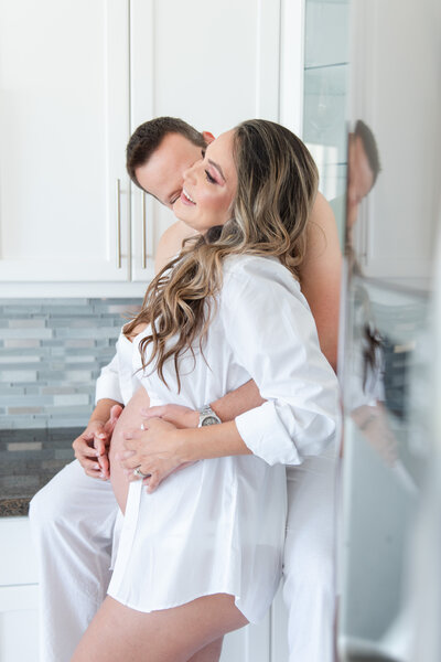 mom and dad maternity session in home on kitchen counter by miami maternity photographer msp photography David and Meivys Suarez