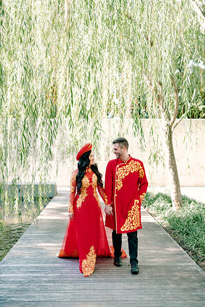 Cultural wedding at the Nasher wedding venue in Dallas. Bride and groom wearing red outfits by Dallas wedding photographer white orchid photography