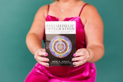 Colorado ketamine therapist holding the book called, "Psychedelic Integration"