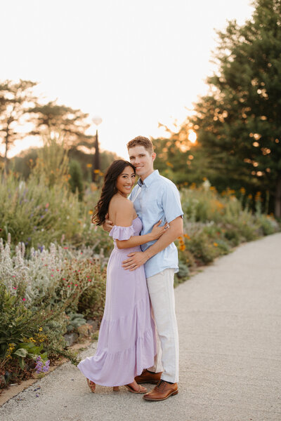Brunette woman and blonde man at Forest Park looking at camera
