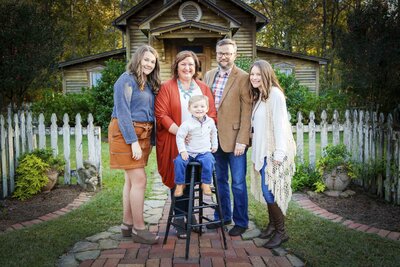 Family poses outside of their SC house for family portraits