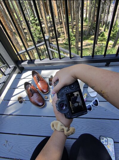 A POV image of Danielle Rose Photography capturing photos during an elopement in Breckenridge, Colorado, showcasing the stunning backdrop of the mountains and the intimate moments of the couple's special day.