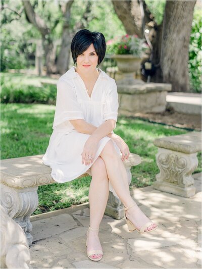 Amy Odom sitting on a bench at Laguna Gloria in Austin, Texas
