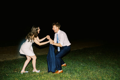The bride and groom dance for a photo with direct flash by destination photographer My Sun and Stars Co.