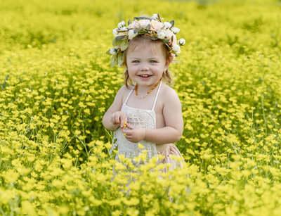 little girl in  yellow flowers