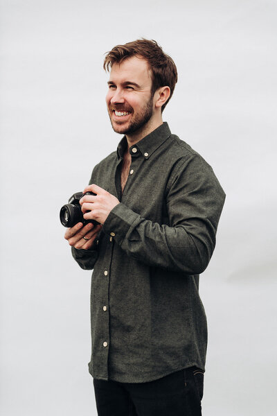 Portrait of Tom Keenan holding his camera