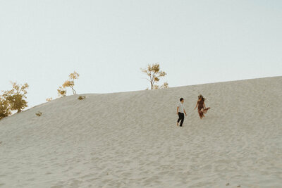 couple running across sand