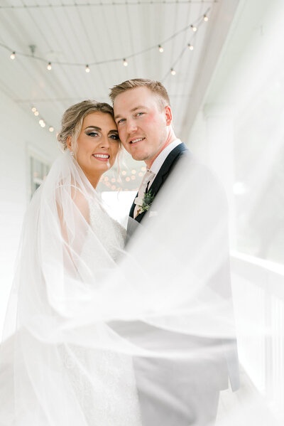 Bride and groom portrait with veil