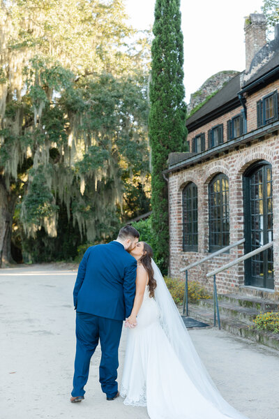 bride and groom kissing in middleton place
