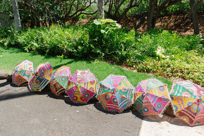 Colorful umbrellas laid out on a sidewalk 