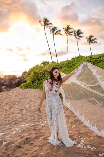 Maui Elopement Photographer captures bride's veil blowing in wind during outdoor bridal photos