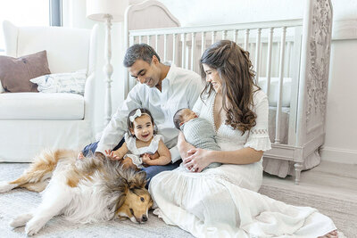 family of 4 with dog for newborn photos with Ivanna Vidal Photography