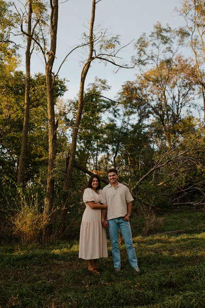 Romantic Omaha engagement session during the fall, captured by Tori Nichole Photography. The couple is surrounded by vibrant autumn foliage and golden light, creating warm, timeless moments. A perfect blend of natural beauty and authentic connection, showcasing the magic of the season and their love story.