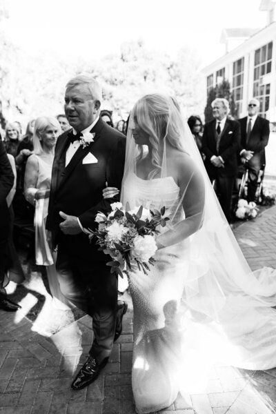Bride walking down the aisle with her father during the ceremony