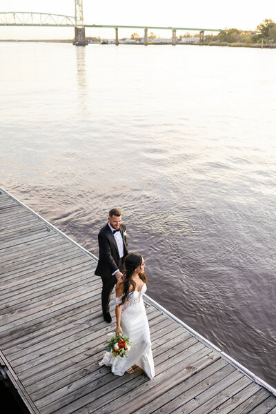 Bride and groom walking in downtown Wilmington NC wedding photography