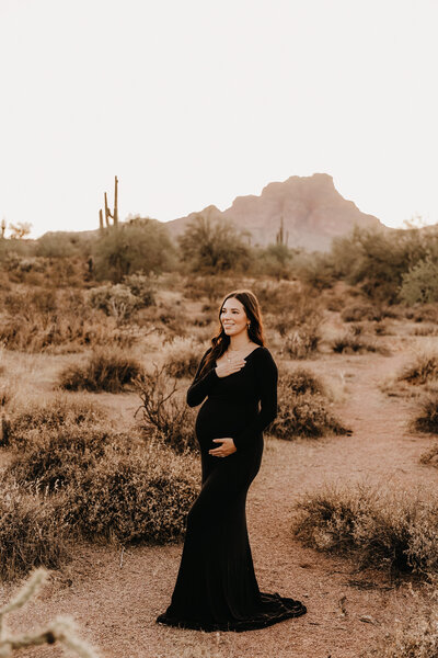 mom in black dress at sunset for phoenix maternity session
