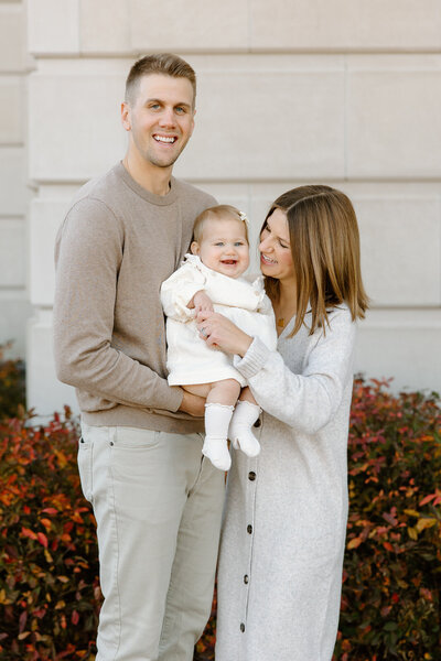 Family of three outside of The Palladium in Carmel, Indiana during photos session with  Indianapolis newborn and family photographer Capturing Simplicity Photography