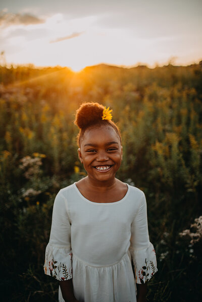 A photo of a little girl at sunset posing for family photos at sunset in Marietta, GA