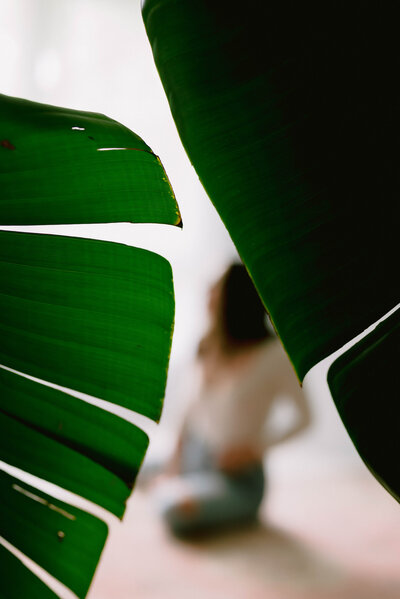 Blurred photo of Jessica behind leaves.







