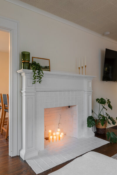 White fireplace with candles