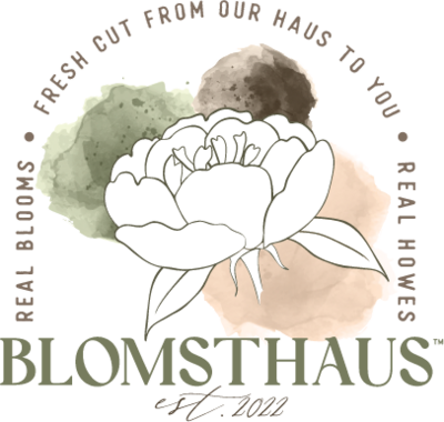 A logo with a white peony in the center in front of three water color blobs varying in green, brown, and tan. Text arching around the top saying 'Reel Blooms, Fresh Cut From Our Haus To You, Real Howes' with 'Blomsthaus, est 2022' listed horizontally to cap the end.