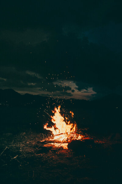 Woman standing on rocks near a waterfall