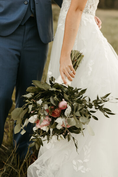 Bride holding bouquet towards side