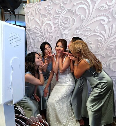 Bride posing with bridesmaids at her wedding reception