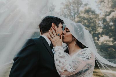 newlyweds kiss under veil